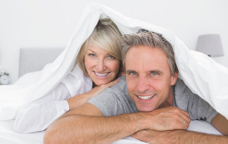 Hormone Replacement Therapy Cost Per Month Happy Older Couple Under the Blanket